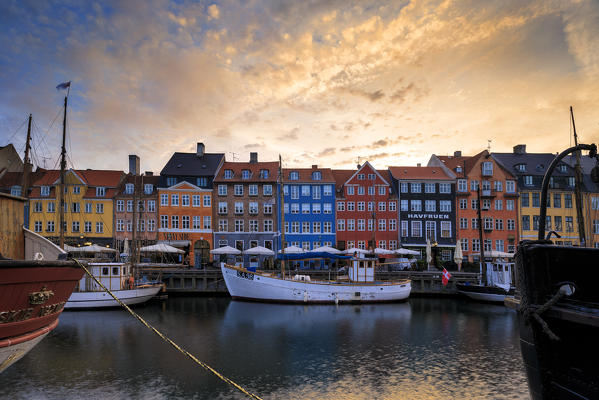 Sunrise on the colourful facades along the harbor in the district of Nyhavn, Copenhagen, Denmark, Europe