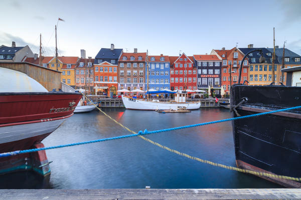 Colourful facades and typical boats along the canal and entertainment district of Nyhavn, Copenhagen, Denmark, Europe
