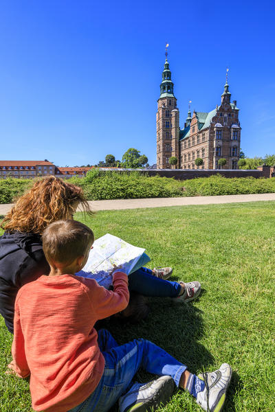 Mother and son look the Rosenborg Castle from the gardens, Copenhagen, Denmark