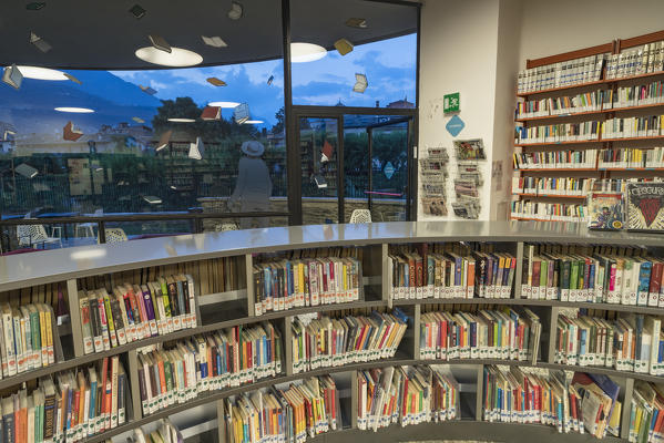 Books on shelves in the library (Biblioteca civica Ezio Vanoni), Morbegno, Sondrio province, Valtellina, Lombardy, Italy