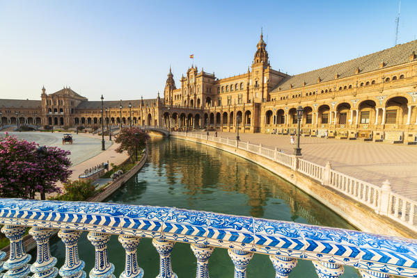 Overview of canal and portico from a decorated glazed ceramic balustrade, Plaza de Espana, Seville, Andalusia, Spain