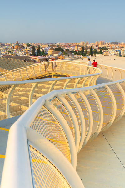 People on curved footbridge admires the city skyline, Metropol Parasol, Plaza de la Encarnacion, Seville, Andalusia, Spain