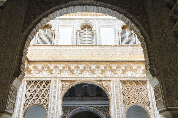 Details of Mudejar architecteure on archways and windows at the entryway of Doll's Courtyard, Real Alcazar, Seville, Andalusia, Spain