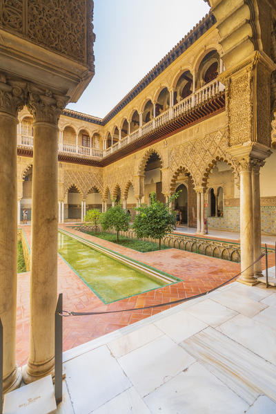 Patio de las Doncellas, a decorated courtyard and pool in typical Mudejar architecteure. Real Alcazar, Seville, Andalusia, Spain