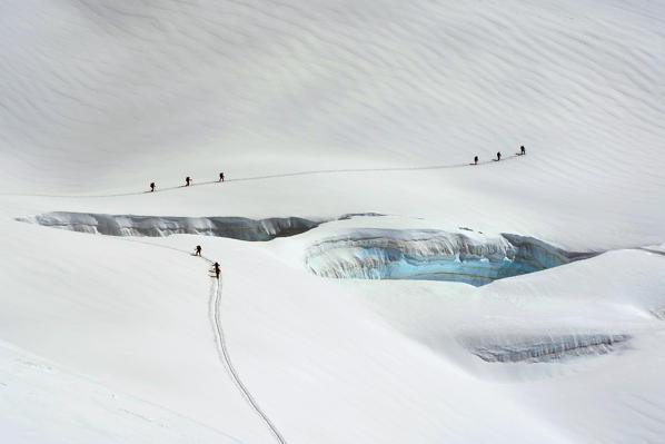 Mountaineers aroud crevasses on Monte Rosa, Aosta Valley, Itlay, Europe