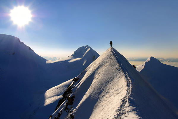 Mountaineers on sharpened ridg on Lyskamm (eastern), Aosta Valley, Italy, Europe