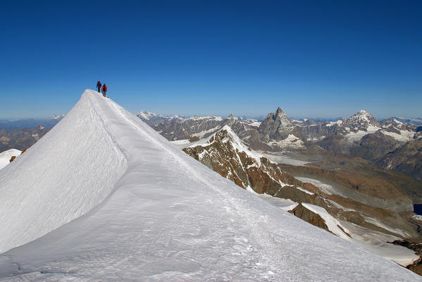 Mountaineers climbing sharpened ridg on Lyskamm (western), Aosta Valley, Italy, Europe