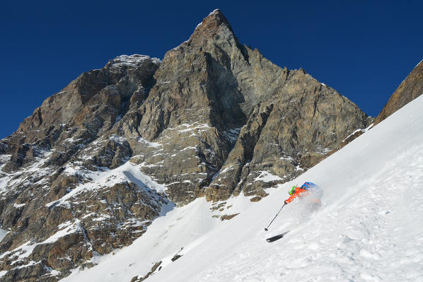 Ski Mountaineers form Furggen Pass with Matterhorn (Cervino) on background, valtournenche, Aosta Valley, Italy 