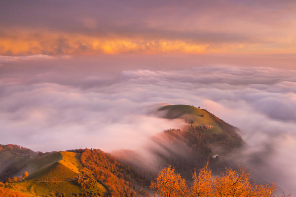 The sunset above the clouds over Prealpi Orobiche. Bronzone Mount (Prealpi Orobiche). Viadanica, Bergamo province, Lombardy, Italy, Europe