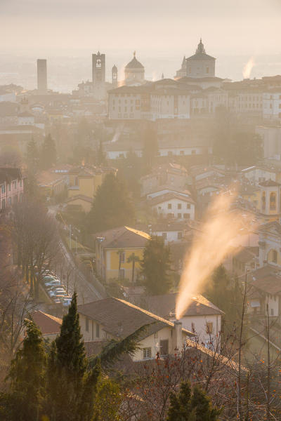 A cold morning in Bergamo upper town with some fog and smoke from the chimneys. Bergamo Upper Town (Città Alta), Bergamo province, Lombardy district, Italy, Europe