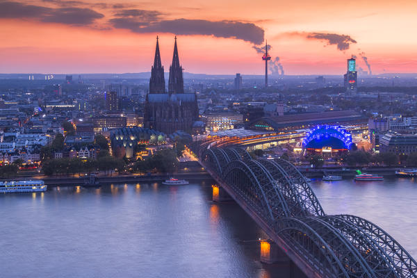 Cologne Cathedral and Hohenzoller Bridge over River Rhine in Cologne city at dusk. Cologne city (Koln), North Rhine Westphalia, Germany, Europe. 