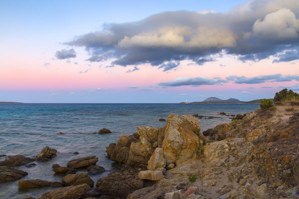 Rocks in Rena Bianca beach at dusk, Portisco (Olbia) Costa Smeralda, Olbia-Tempio province, Sardinia district, Italy