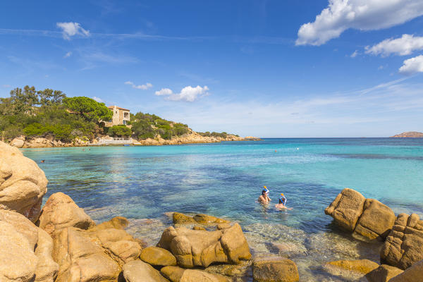 Couple of tourists snorkel in crystal turquoise water in Capriccioli beach, Arzachena Costa Smeralda, Olbia-Tempio province, Sardinia district, Italy