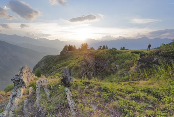 Hiker that admires the sunset, Ozein, Aymavilles, Aosta Valley, Italy