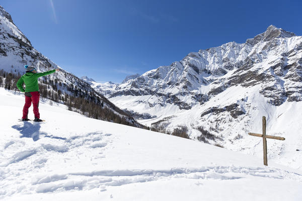 Skier admires mountaind in Rhemes Notre Dame valley,Aosta Valley,Italy