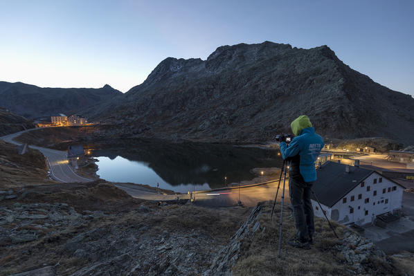 Photographer in action at Gran San Bernardo Pass in autumn, Aosta Valley, Italy, Europe