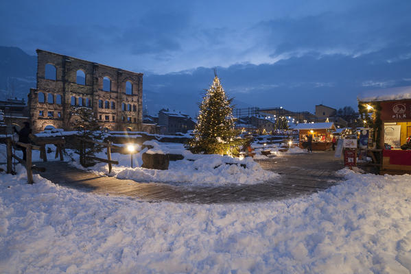 Roman theatre and Christmas markets in Aosta at dusk, Aosta Valley, Italy