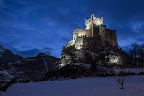 Saint-Pierre castle in winter at dusk, Aosta Valley, Italy