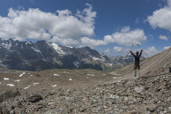 Hiker rejoices while admiring the Valgrisenche, Aosta Valley, Italy