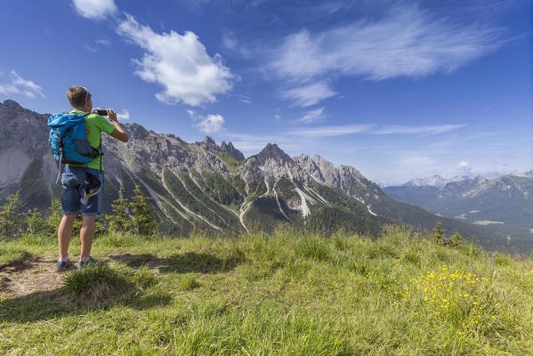 Hikers admires Val Sesis, Sappada, Belluno, Veneto, Italy