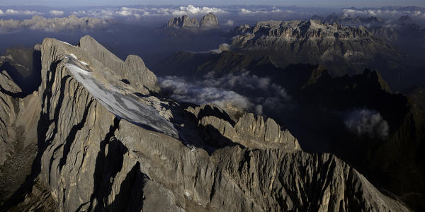 An Aerial view from the east side of Marmolada, the highest mountain of dolomites, 3343m. (10.967ft) above sea level. On background, the Padon mountain, Sella and Sassolungo groups. It lies between the borders of the Veneto and Trentino Alto Adige regions. Italy. Europe. 