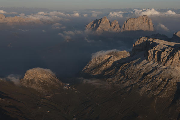 Aerial view of the Pordoi Pass, under the big walls of the Sella group. On background, the Sassolungo group, Dolomites. Trentino Alto Adige region. Italy, Europe 