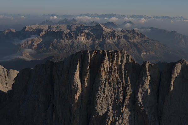 The big south side wall of Marmolada. Marmolada group, Dolomites. lies between the borders of Trentino and Veneto regions. On background, the Sella Group mountain.  Italy. Europe