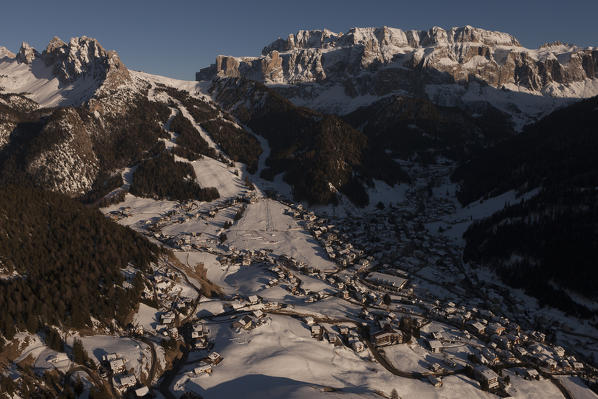 Aerial view over Val Gardena. On background, the Val Gardena pass and Sella group. Dolomites, Bolzano province, Trentino Alto-Adige region. Italy, Europe