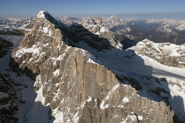 An aerial view of the majestic west side wall of Civetta mountain, 3220m.asl (10.564ft). Dolomites. Belluno province, Veneto region, Italy, Europe. 

