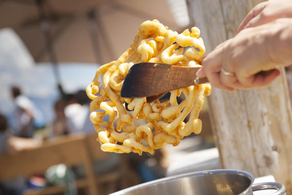 the Strauben: a typical fried dessert from South Tyrol cooked during a festival. Bolzano province, South Tyrol, Trentino Alto Adige, Italy, Europe 
