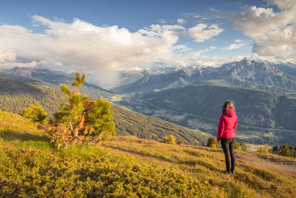 A woman staring at the Rainfall in the Wipptal Valley,  Patscherkofel, Innsbruck, Tyrol, Austria, Europe