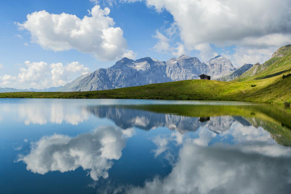 Tribulaun mountain mirroring itself in the waters of Lake Lichtsee, Obernbergtal, Obernberg am Brenner, Innsbruck Land, Tyrol, Austria, Europe
