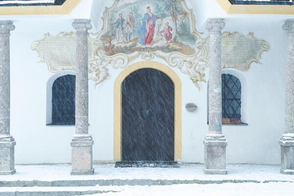 The white facade  of Heiligwasser Church on a snowy day, Igls, Innsbruck, Tyrol, Austria, Europe