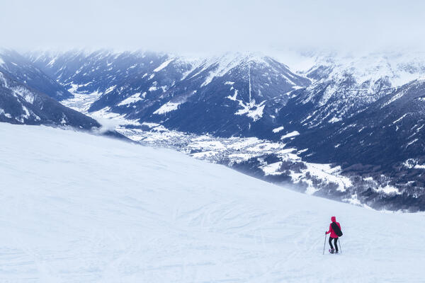 A mountaineer snowshoeing on the snow capped Patscherkofel mountain, with the Stubai Valley in the background, Tux alps, Innsbruck Land, Tyrol, Austria, Europe