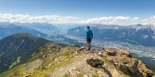 A mountaineer on the summit of Sonnenspitze peak, Glungezer mountain, Tulfes, Innsbruck Land, Tyrol, Austria, Europe