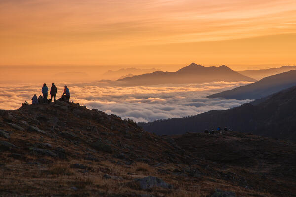 A group of hikers watching the sunrise on the Patscherkofel mountain, Innsbruck Land, Tyrol, Austria, Europe 