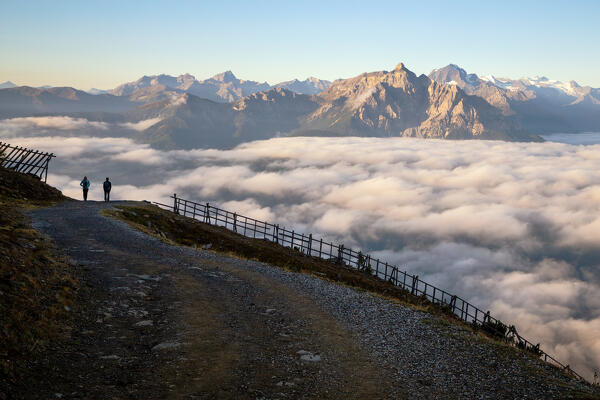 A couple of hikers descending Patscherkofel mountain on a foggy morning, Innsbruck Land, Tyrol, Austria, Europe 
