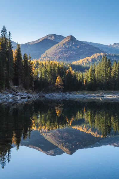 Hoher Sattel and Grubenkopf mountains mirrored in Lake Obernberg, Obernberg am Brenner, Innsbruck Land, Tyrol, Austria, Europe