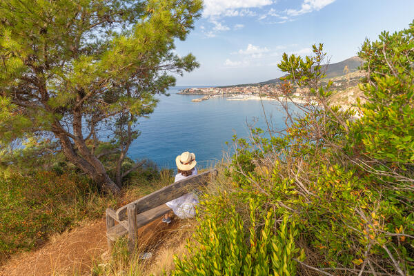 A woman admiring the bay of Lentiscelle and Marina di Camerota, Salerno province, Campania region, Italy, Europe