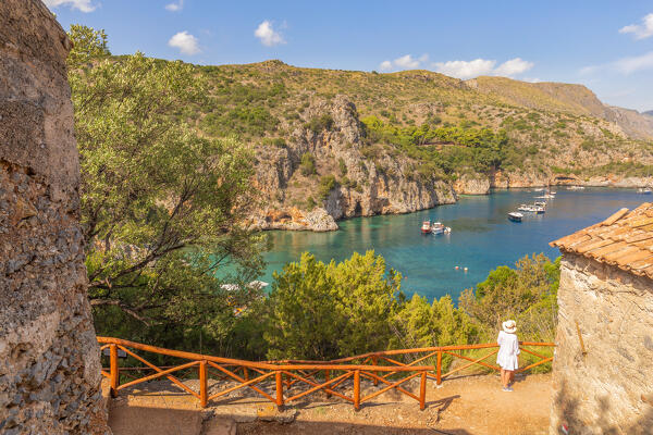 A woman admiring the Infreschi natural harbour, Marina di Camerota, Salerno province, Campania region, Italy, Europe