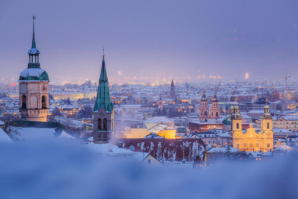 The pictoresque towers of the city of Innsbruck on a snowy evening, Hoetting district, Innsbruck, Tyrol, Austria, Europe