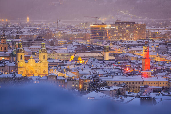 The city center with its iconic buildings as seen from the Hoetting district on a snowy evening, Innsbruck, Tyrol, Austria, Europe