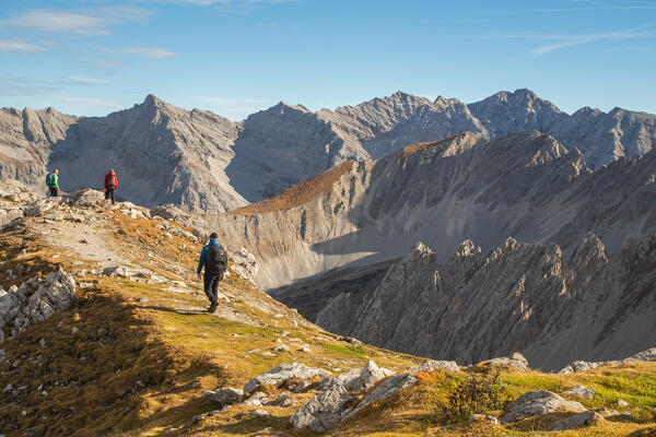 A mountaineer hiking to one of the Karwendel's viewpoint of the Hafelekarspitze mountain on an autumn day, Hafelekar cable car station, Karwendel natural park, Innsbruck, Innsbruck Stadt, Tyrol, Austria, Europe