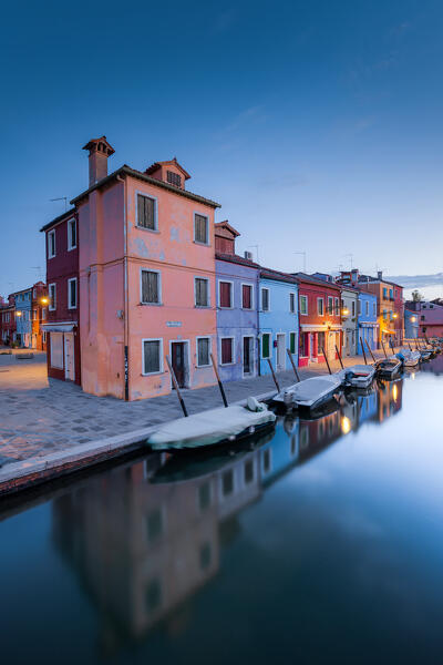 Fondamenta Cavanella with its boats and its colorful buildings before the dawn, Burano island, Venice, Veneto, Italy, Europe