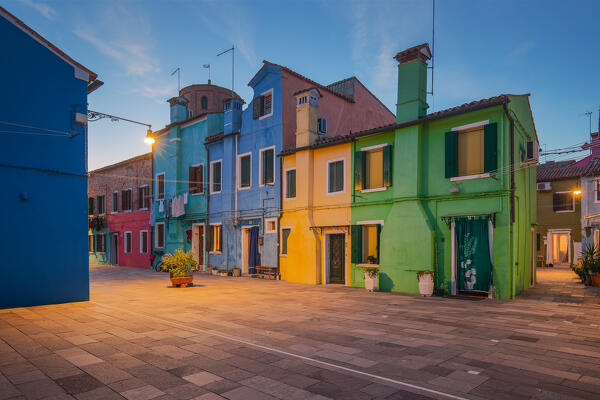 A row of brightly painted buildings at evening, Burano island, Venice, Veneto, Italy, Europe