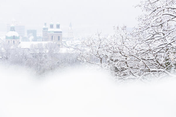 The historic old town of Innsbruck on a snowy day as seen from the woods of Nordkette in the district of Mühlau, Innsbruck Stadt, Tyrol, Austria, Europe