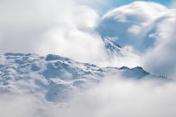 A long exposure portraying the clouds moving between Morgenkogel mountain and Mislkopf mountain on a winter day, Tux Alps, Patsch, Innsbruck Land, Tyrol, Austria, Europe
