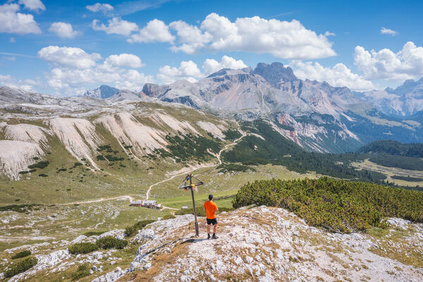A mountaineer admiring the Fanes-Sennes-Braies natural park from the summit of Colle di Lasta Piccolo in the nearby of rifugio Sennes, Bolzano province, Trentino Alto Adige, Italy, Europe