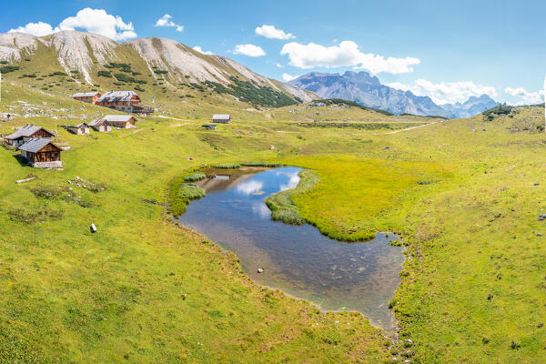 Aerial view of Lake Sennes, rifugio Sennes and its barns on summer day, Fanes-Sennes-Braies natural park, Bolzano province, Trentino Alto Adige, Italy, Europe