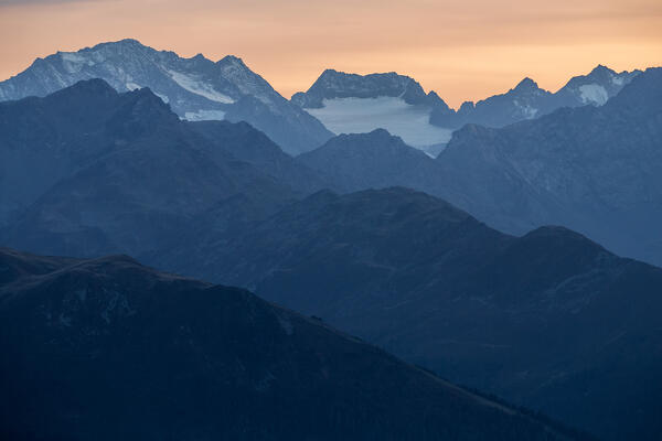 Mountain layers at dusk with the Schwarzenbergspitze mountain and the Alpeiner Glacier in the background, as seen from the Seegrube in Innsbruck, Tyrol, Austria, Europe 